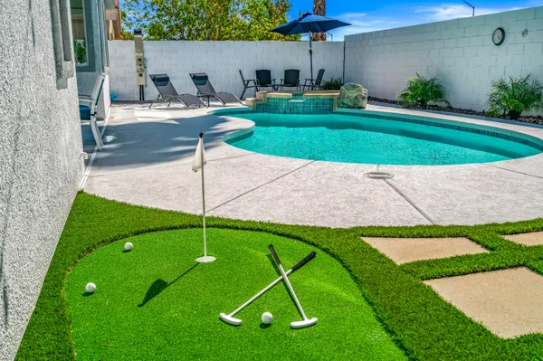 a backyard of a house with table and chairs