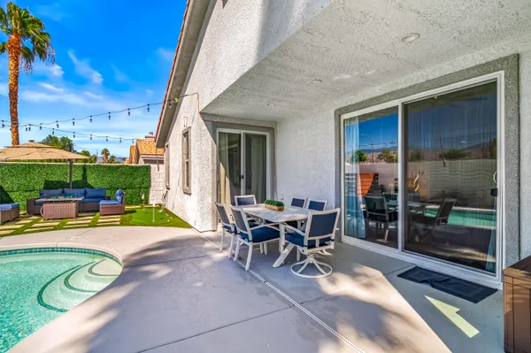 a view of a house with backyard porch and sitting area