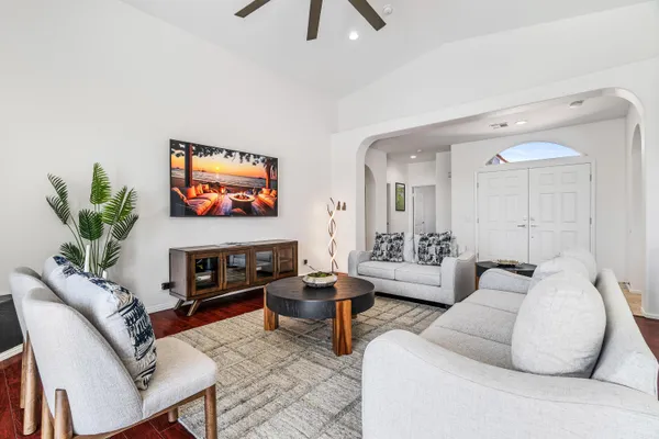 a living room with furniture and a flat screen tv