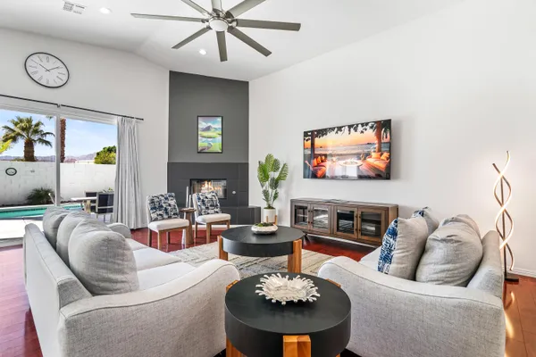 a living room with fireplace furniture and a flat screen tv