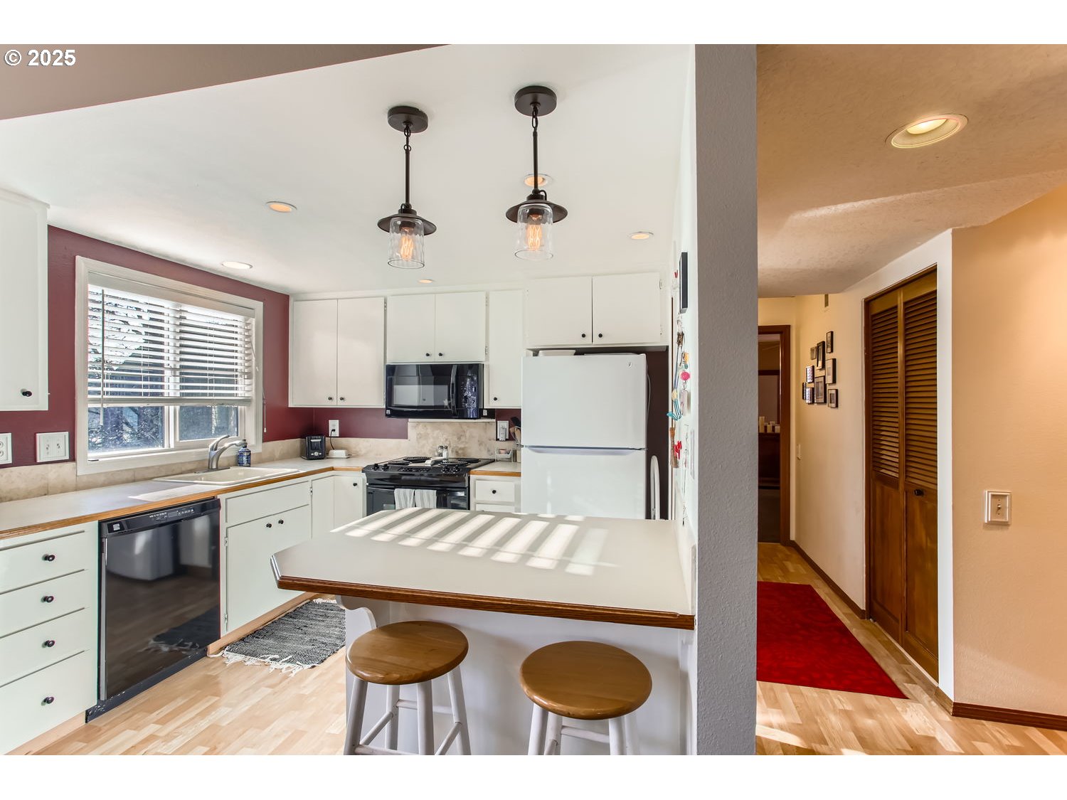 15655 Southwest 114th Court, Unit 10 Portland, OR 97224 - Photo 14 of 27 a kitchen with a stove a refrigerator and a dining table