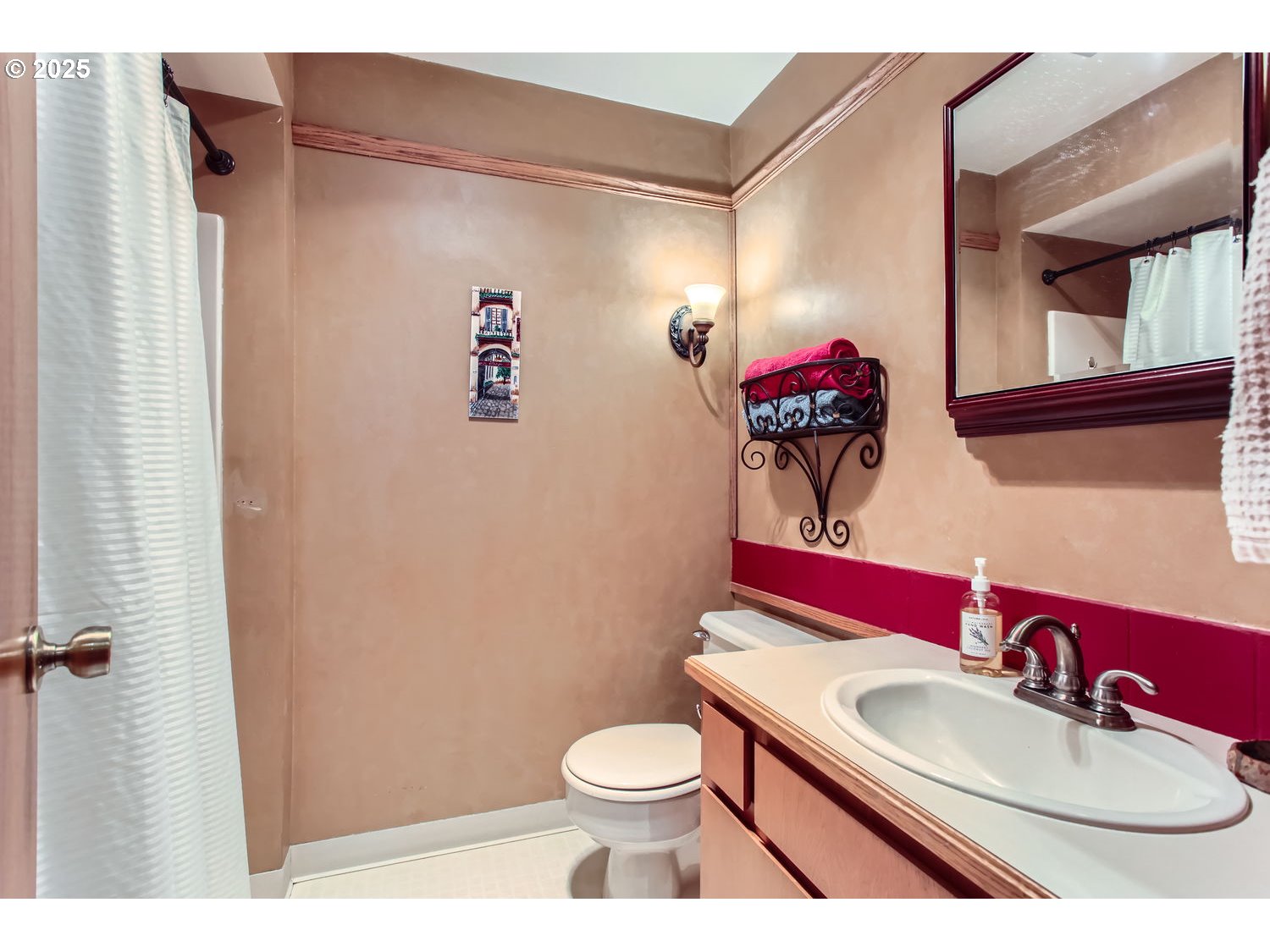 15655 Southwest 114th Court, Unit 10 Portland, OR 97224 - Photo 17 of 27 a bathroom with a toilet sink vanity and mirror