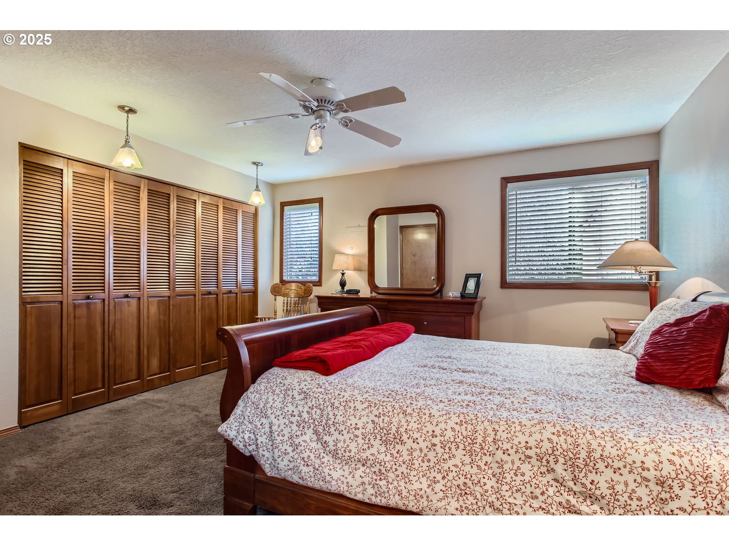 15655 Southwest 114th Court, Unit 10 Portland, OR 97224 - Photo 20 of 27 a bedroom with a large bed and a chandelier