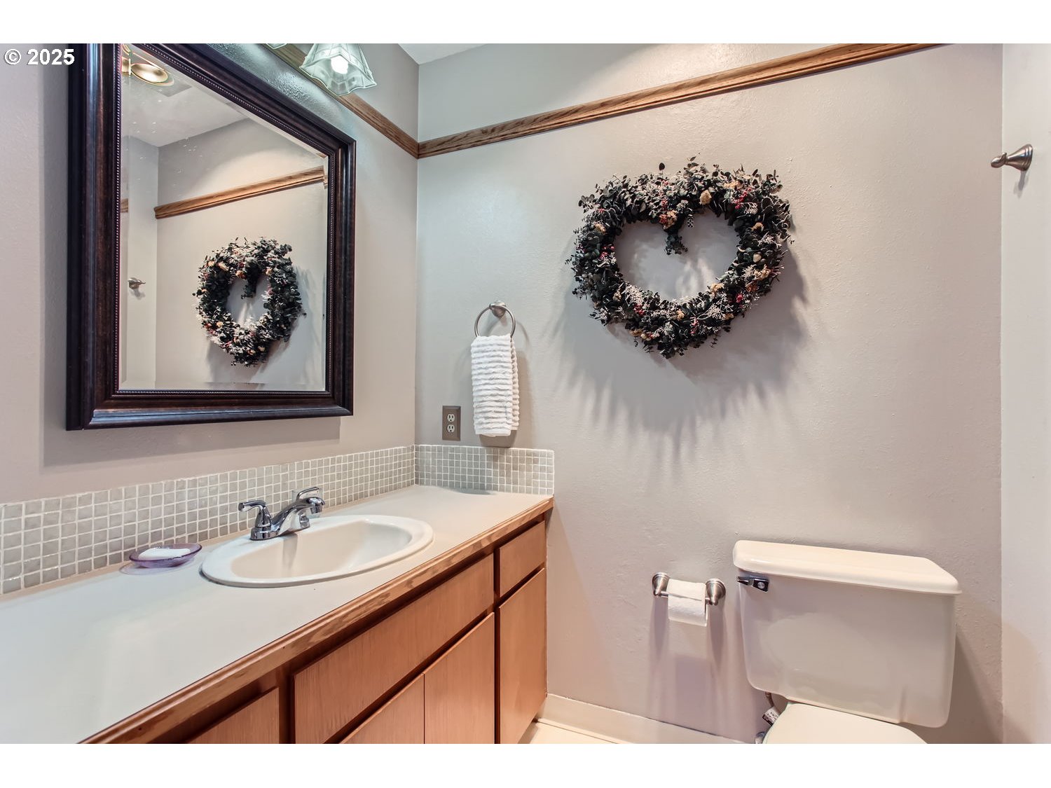 15655 Southwest 114th Court, Unit 10 Portland, OR 97224 - Photo 21 of 27 a bathroom with a sink mirror and vanity