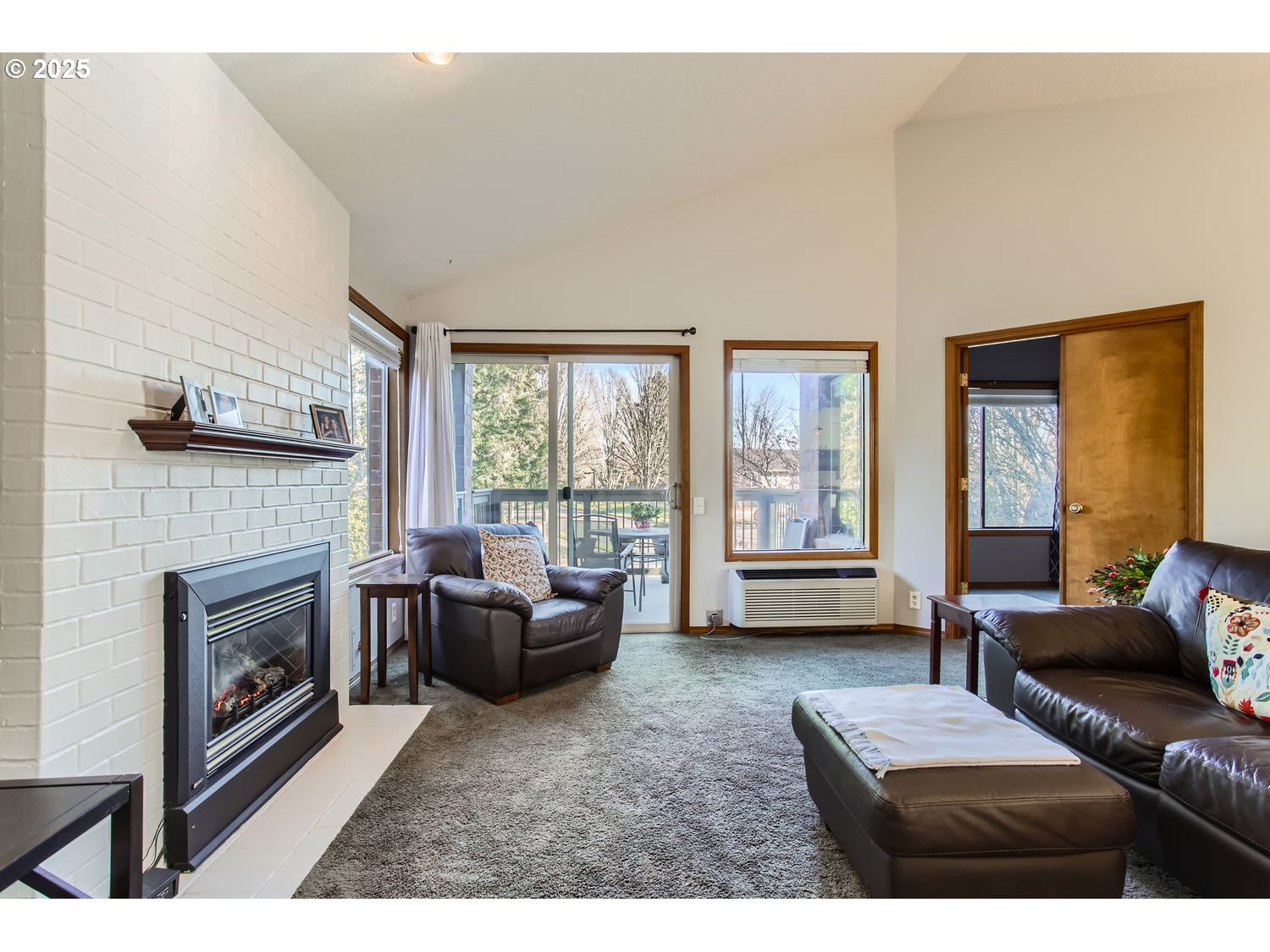 15655 Southwest 114th Court, Unit 10 Portland, OR 97224 - Photo 6 of 27 a living room with furniture a large window and a fireplace