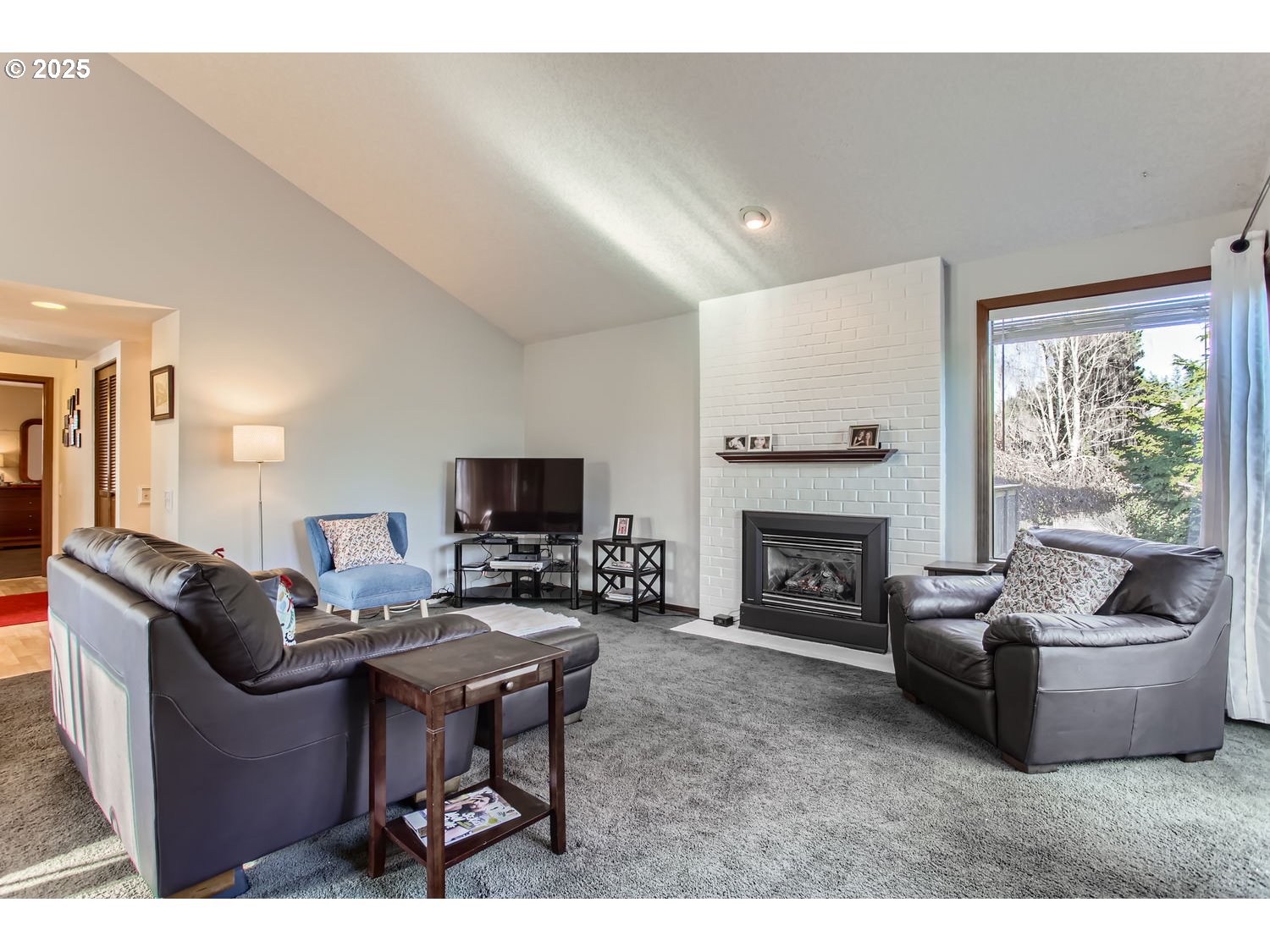 15655 Southwest 114th Court, Unit 10 Portland, OR 97224 - Photo 9 of 27 a living room with furniture a fireplace and a flat screen tv
