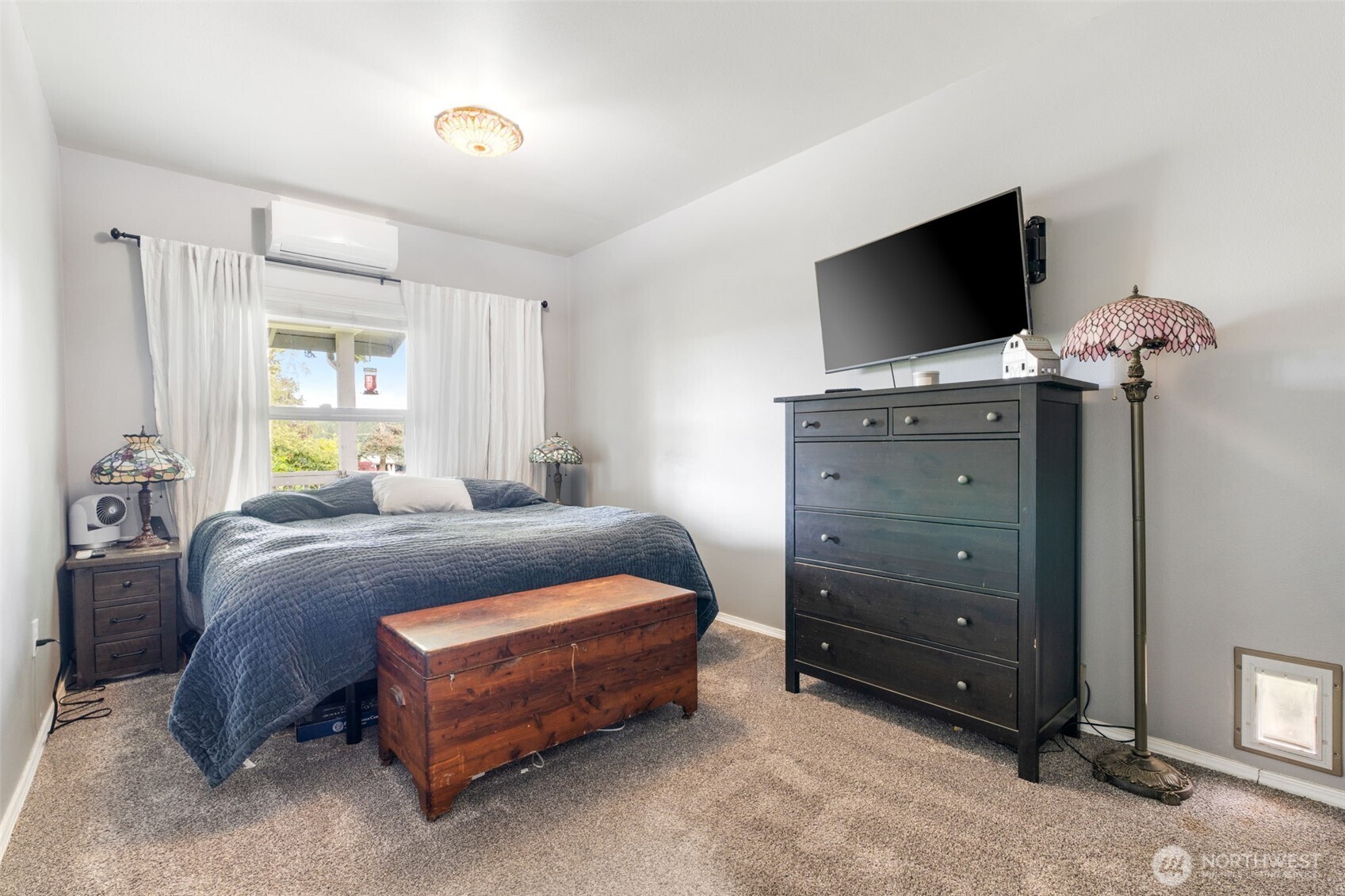 2163 Wildwood Road Curtis, WA 98538 - Photo 13 of 36 a bedroom with a bed and a flat tv screen on dresser