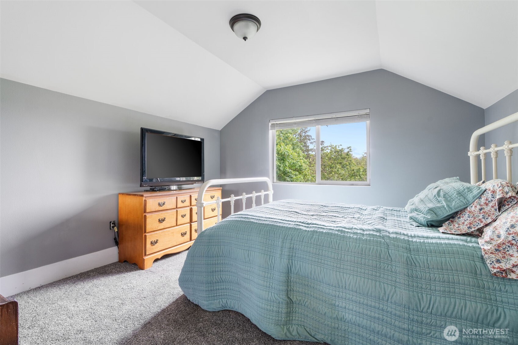 2163 Wildwood Road Curtis, WA 98538 - Photo 18 of 36 a bedroom with a bed and a flat screen tv