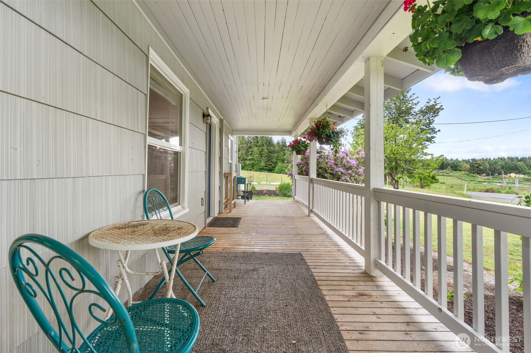 2163 Wildwood Road Curtis, WA 98538 - Photo 21 of 36 a view of a patio with table and chairs potted plants with floor to ceiling window