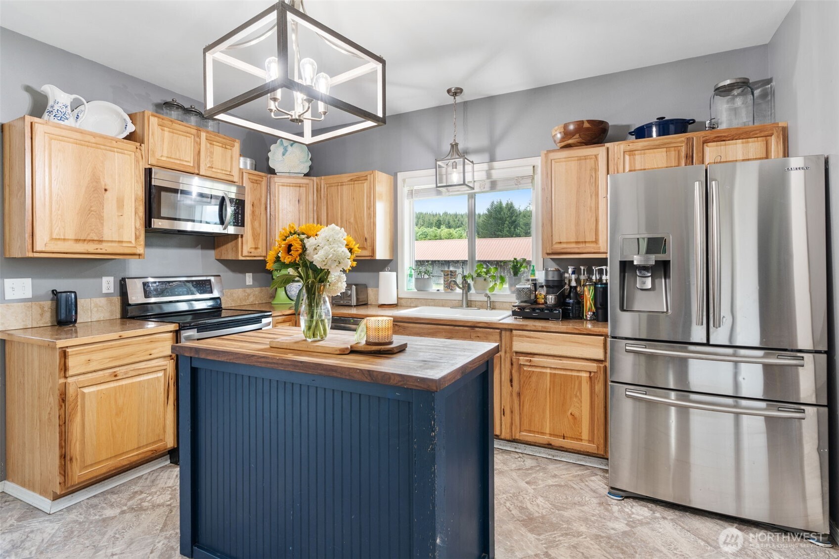 2163 Wildwood Road Curtis, WA 98538 - Photo 7 of 36 a kitchen with stainless steel appliances granite countertop a refrigerator a stove a sink dishwasher and white cabinets with wooden floor