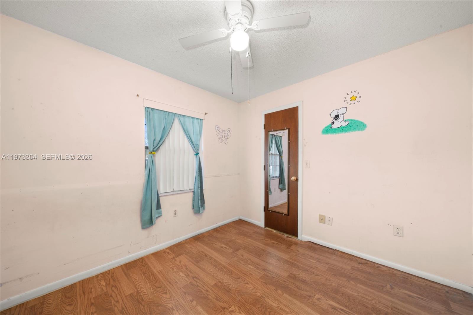2067 North Terrapin Road Avon Park, FL 33825 - Photo 21 of 43 a view of empty room with wooden floor and fan