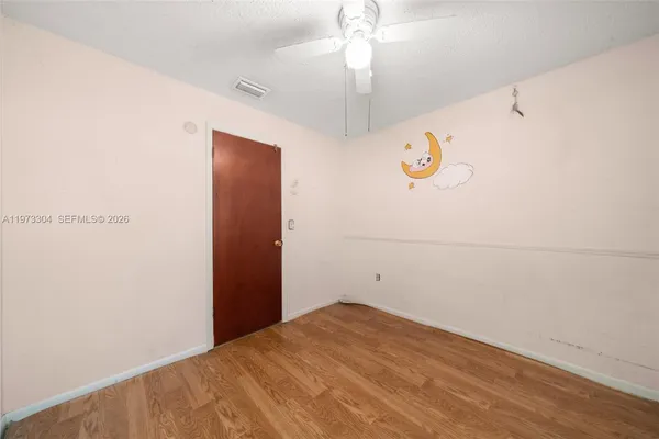 a view of a room with wooden floor