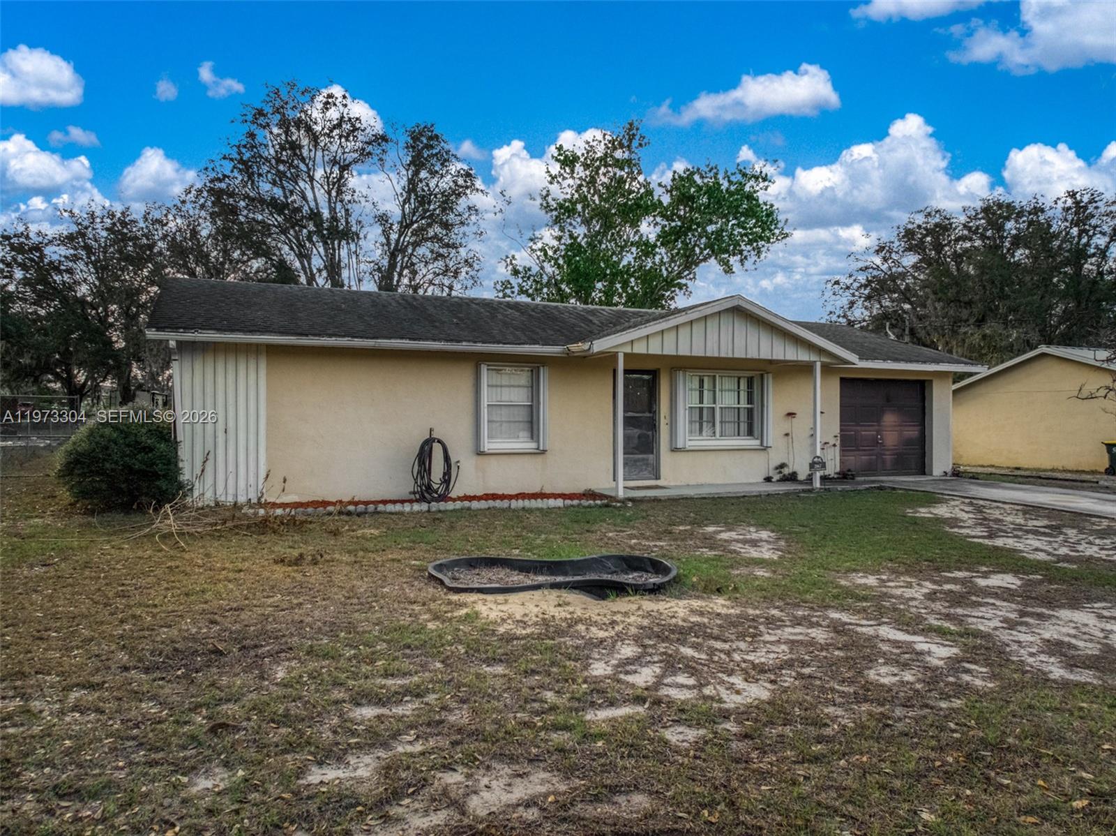 2067 North Terrapin Road Avon Park, FL 33825 - Photo 35 of 43 a front view of house with yard and trees in the background