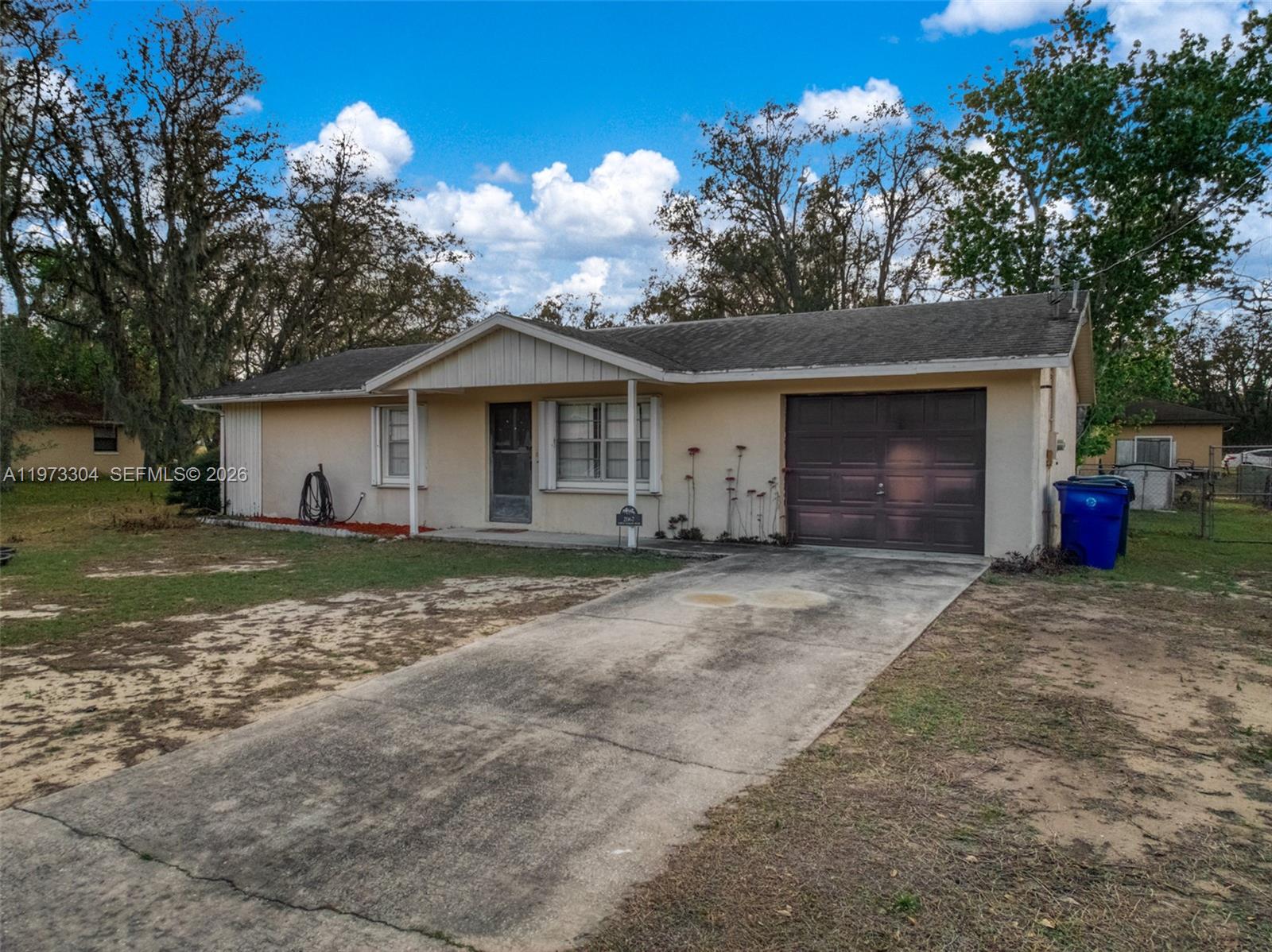 2067 North Terrapin Road Avon Park, FL 33825 - Photo 36 of 43 a front view of a house with a yard and garage