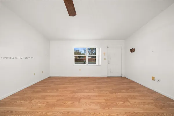 a view of an empty room with windows