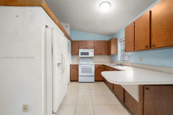 a kitchen with stainless steel appliances a sink and a refrigerator