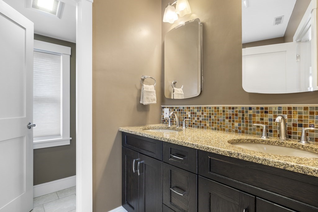 20 Richard Road Lexington, MA 02421 - Photo 15 of 28 a bathroom with a granite countertop double vanity sink and a mirror