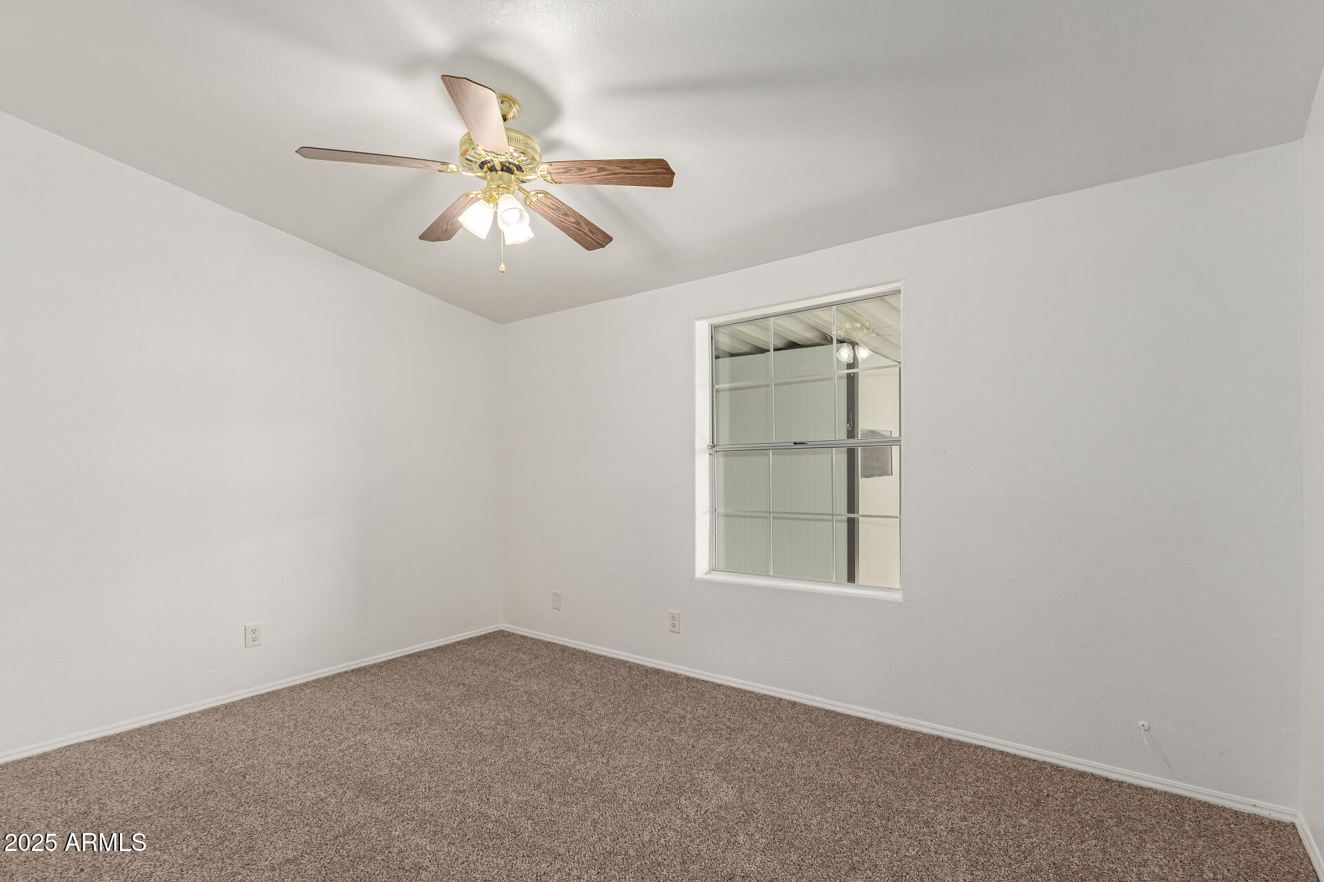 2311 South Descanso Road Apache Junction, AZ 85119 - Photo 14 of 35 an empty room with a window and a fan