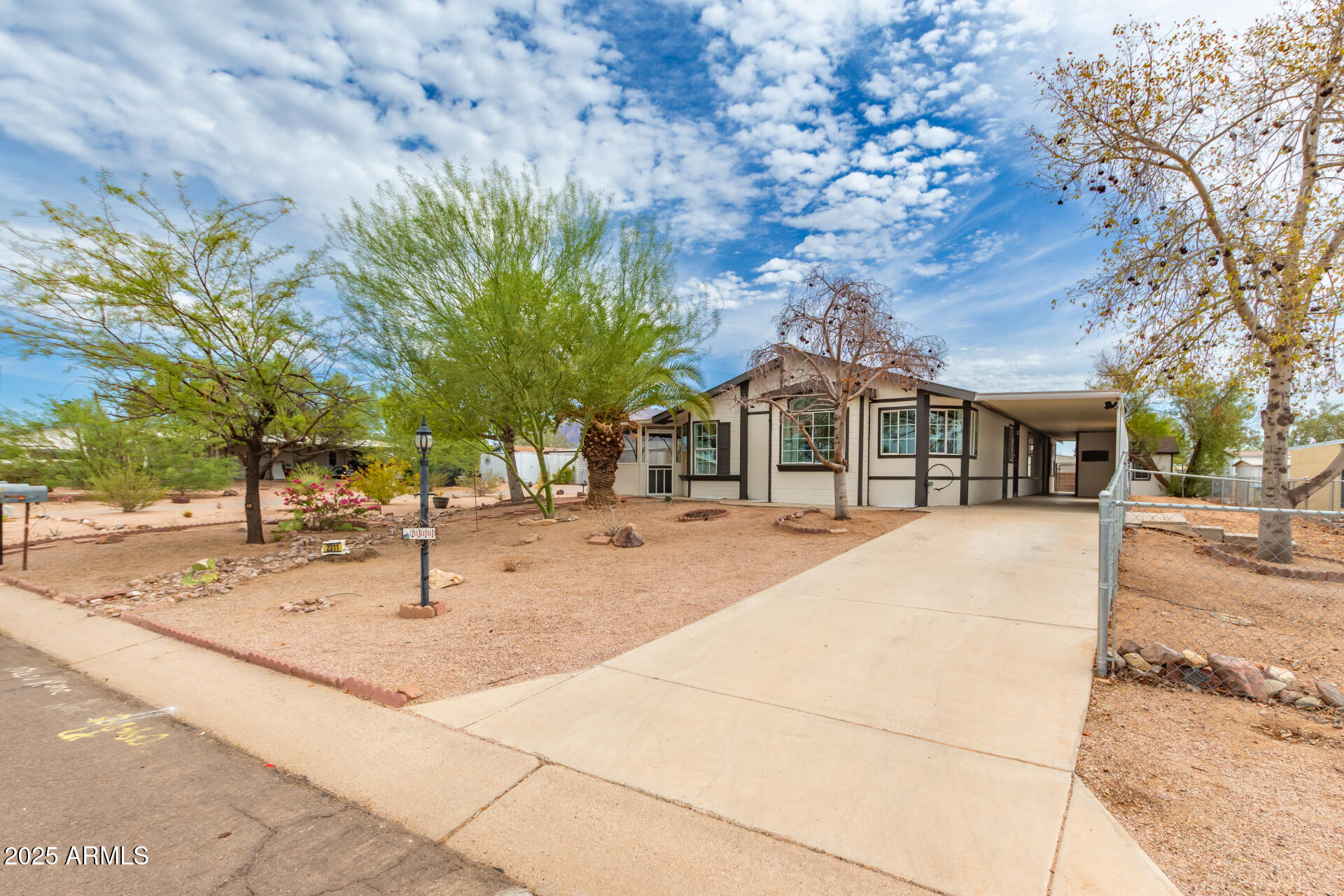 2311 South Descanso Road Apache Junction, AZ 85119 - Photo 2 of 35 a front view of a house with a garden