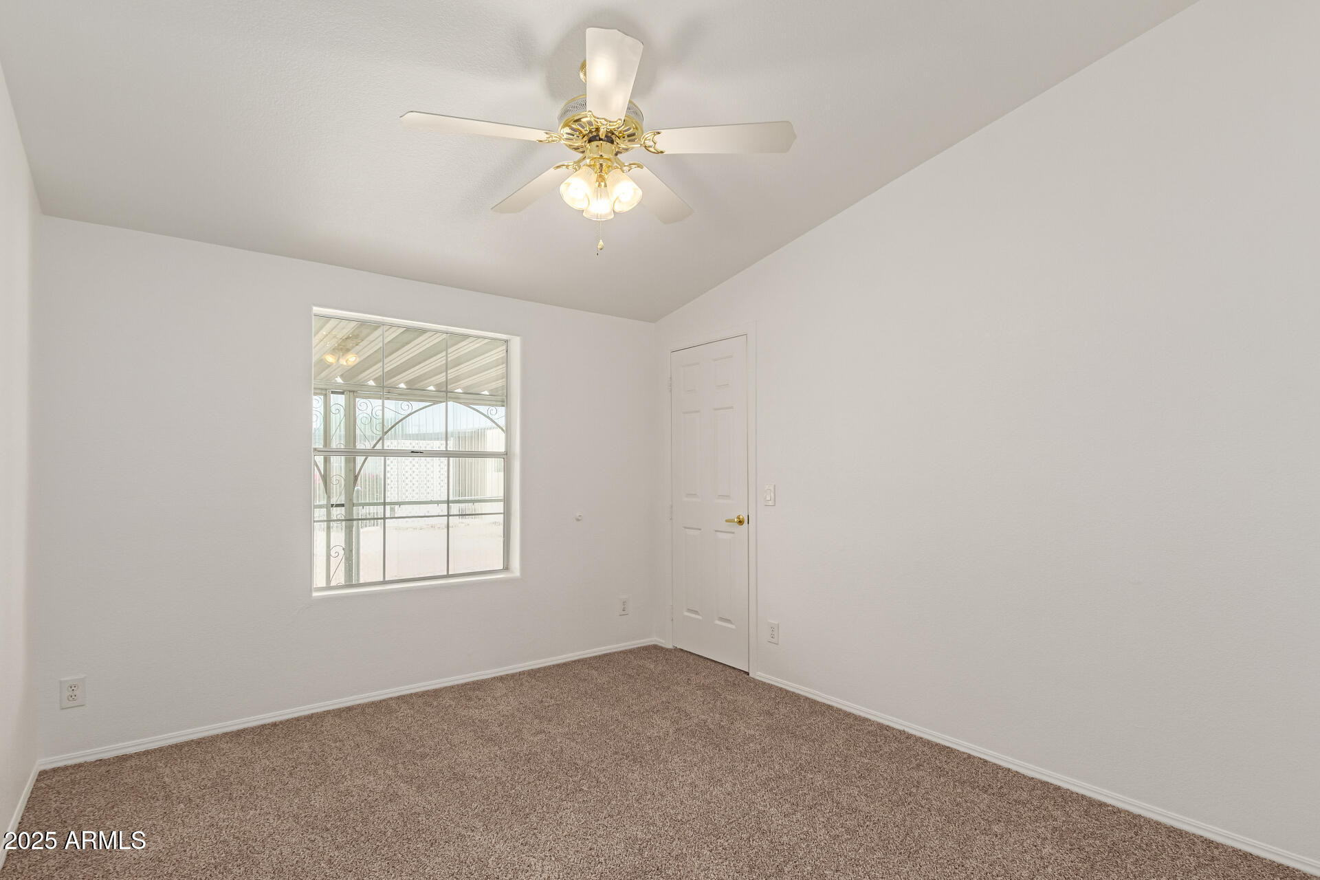 2311 South Descanso Road Apache Junction, AZ 85119 - Photo 23 of 35 an empty room with windows and fan