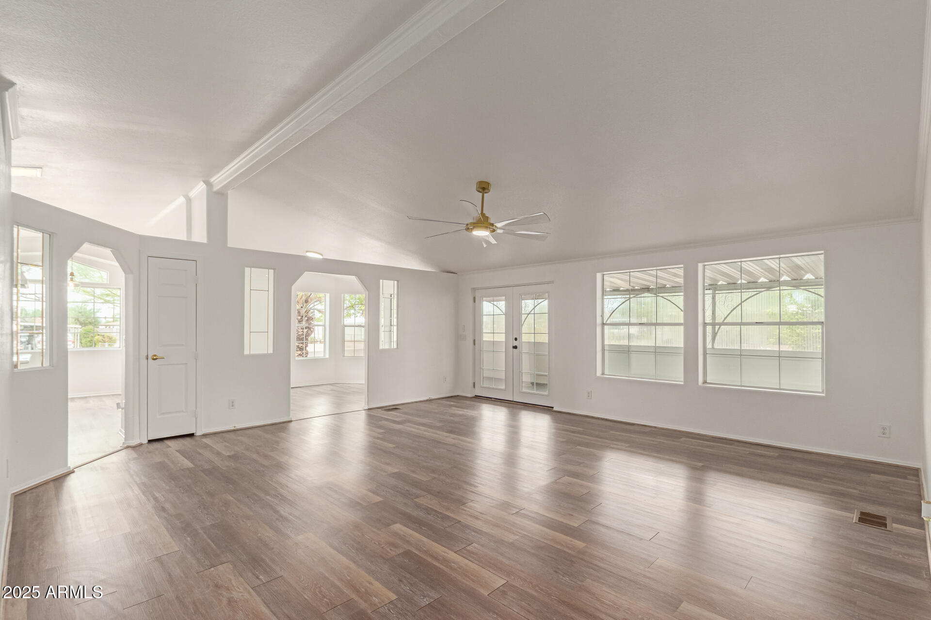 2311 South Descanso Road Apache Junction, AZ 85119 - Photo 4 of 35 a view of an empty room with wooden floor and a window