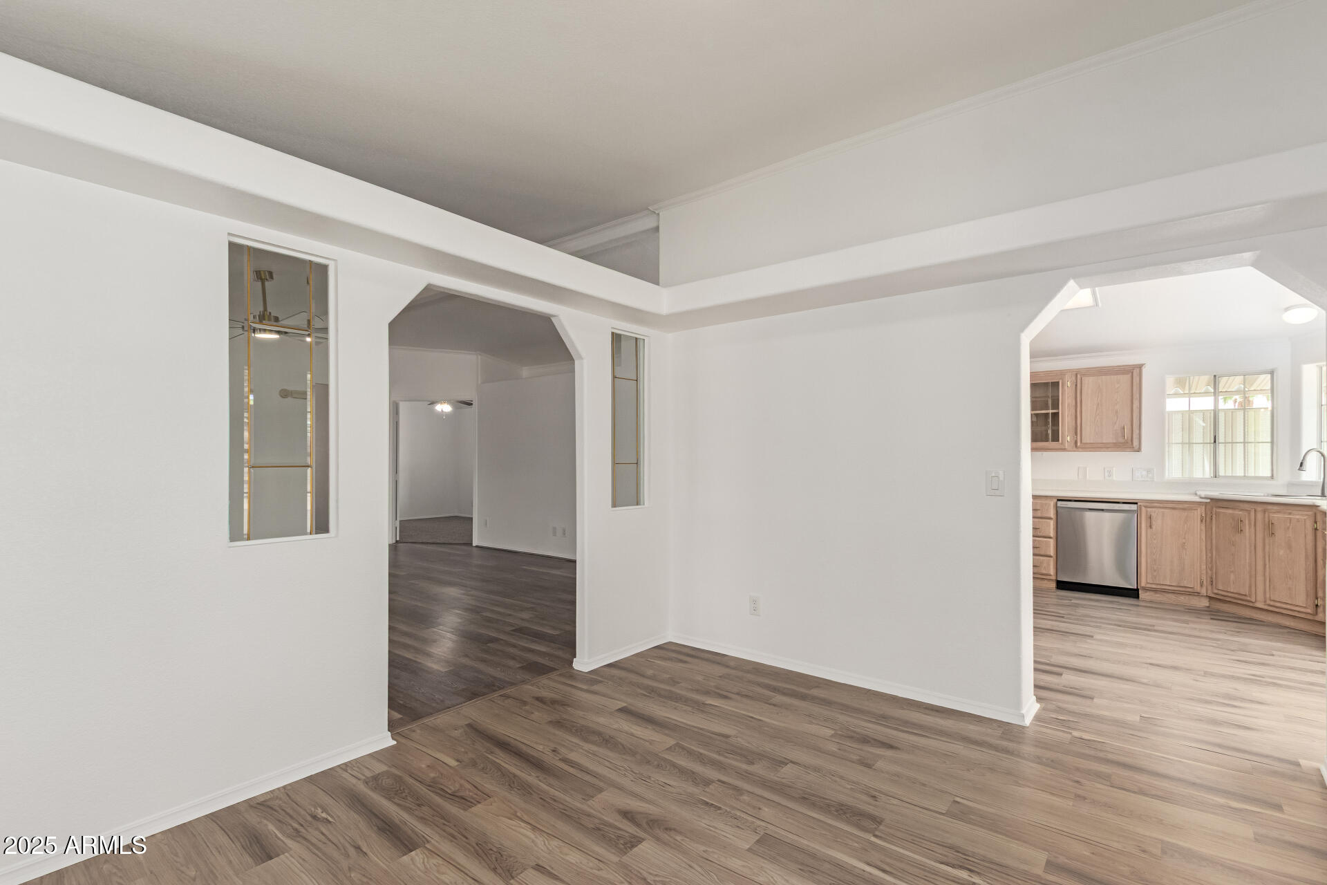 2311 South Descanso Road Apache Junction, AZ 85119 - Photo 8 of 35 a view of a hallway with wooden floor and a kitchen