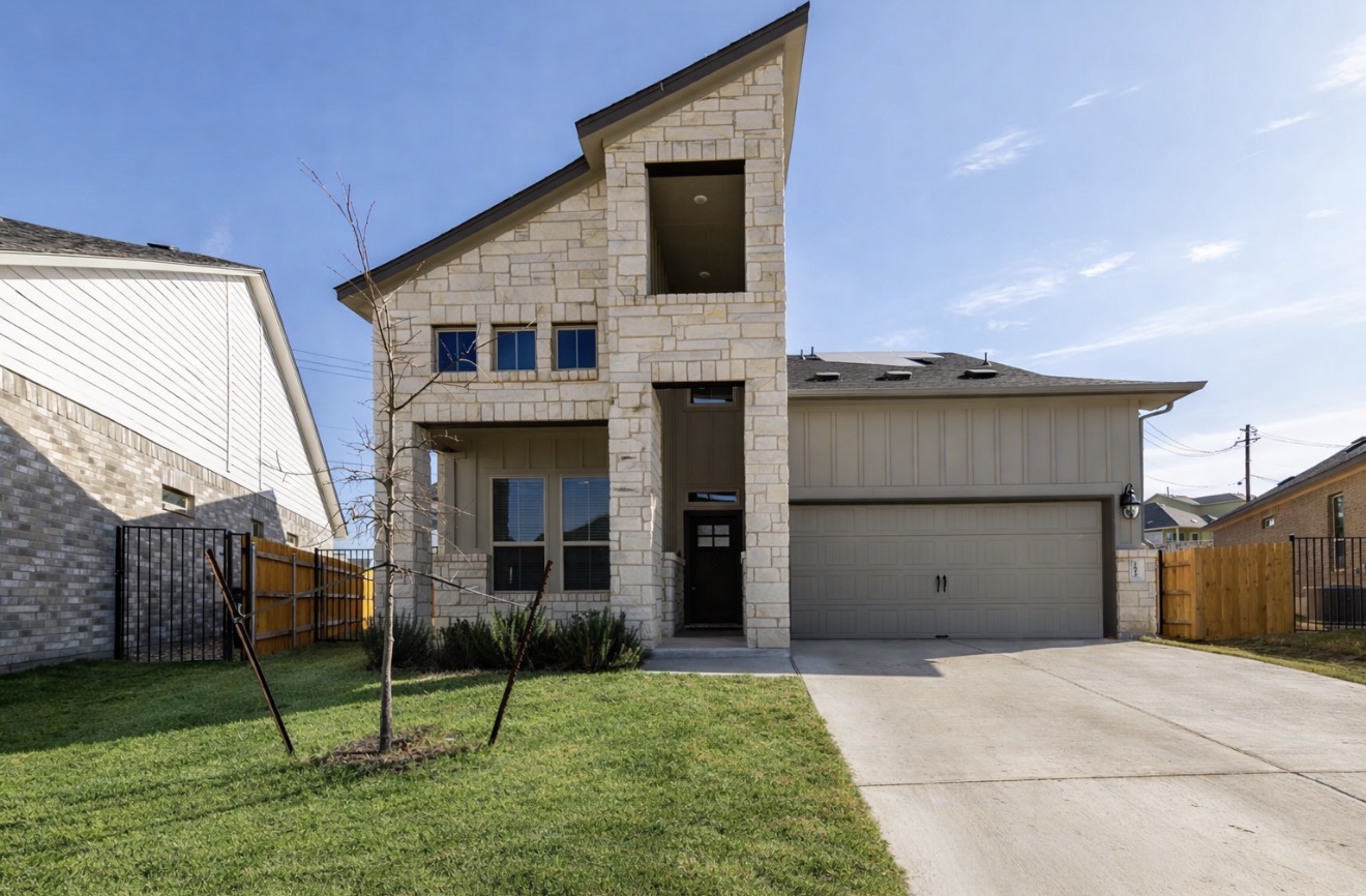 2812 Sebring Circle Austin, TX 78747 - Photo 1 of 40 View of front of house with an attached garage, stone siding, concrete driveway, and board and batten siding
