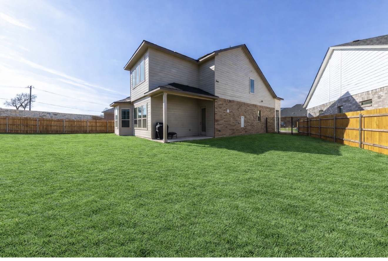 2812 Sebring Circle Austin, TX 78747 - Photo 38 of 40 Back of house with a patio, a fenced backyard, and brick siding