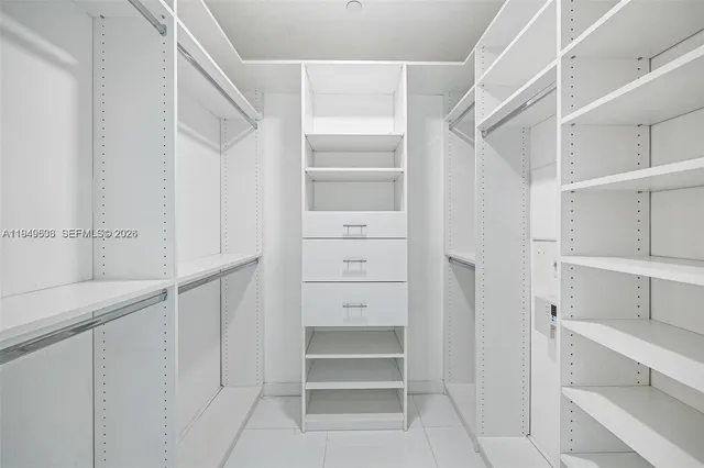 a view of walk in closet with empty racks