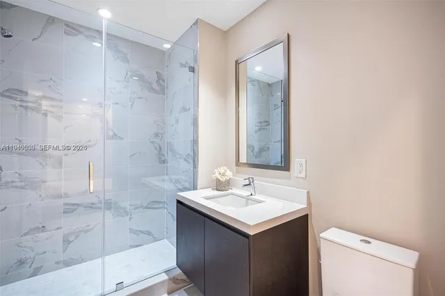 a bathroom with a sink mirror and a shower