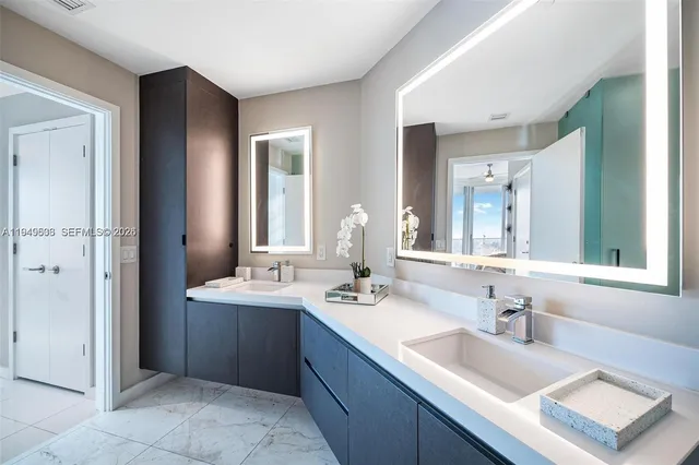 a bathroom with a sink double vanity and a mirror
