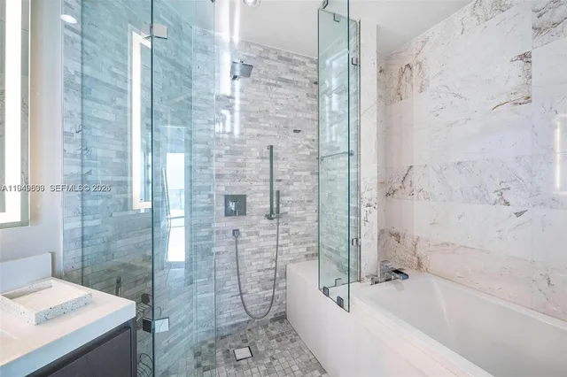 a bathroom with a bathtub and shower