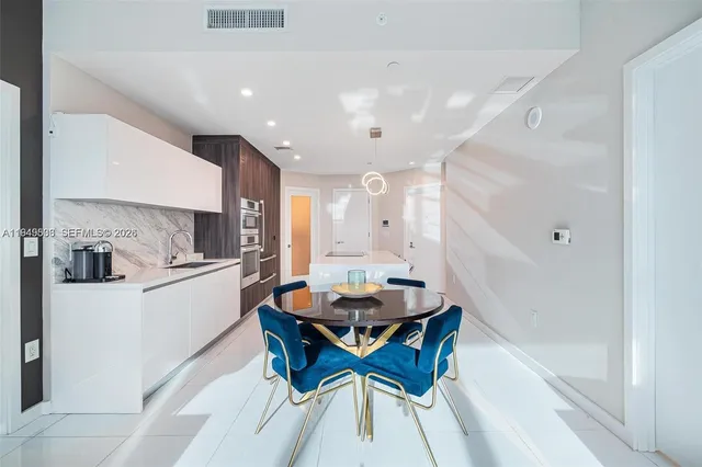 a kitchen with stainless steel appliances kitchen island granite countertop a sink and cabinets