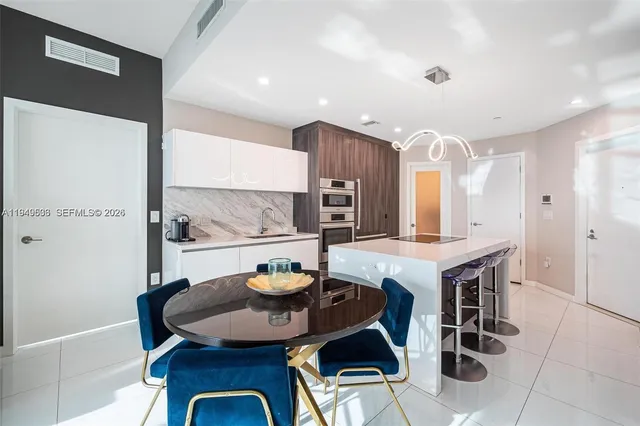 a kitchen with a table and chairs in it