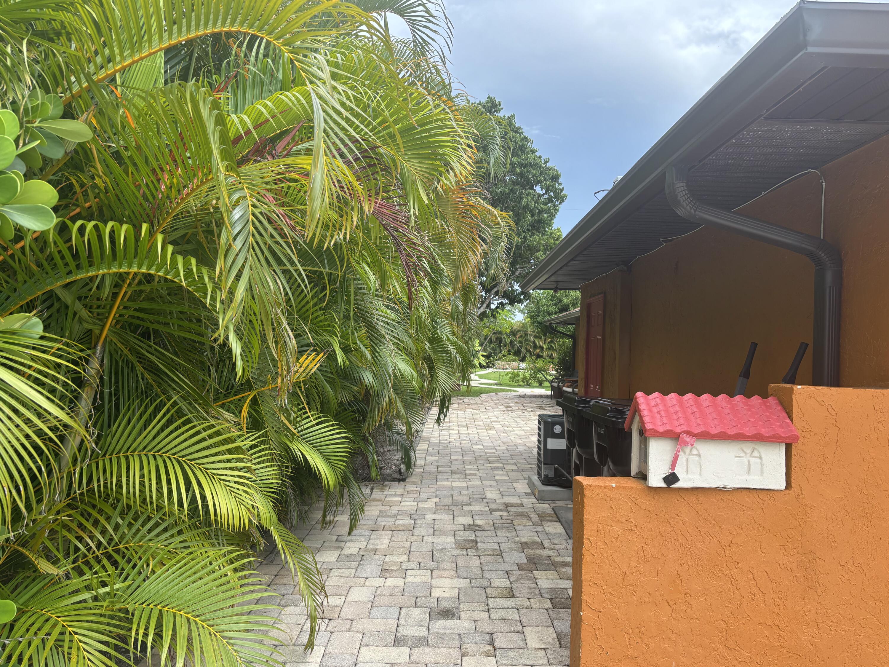 1257 Southeast Airoso Boulevard, Unit B Port St. Lucie, FL 34983 - Photo 4 of 12 a backyard of a house with seating space