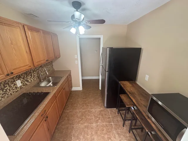 a kitchen with a sink appliances and cabinets