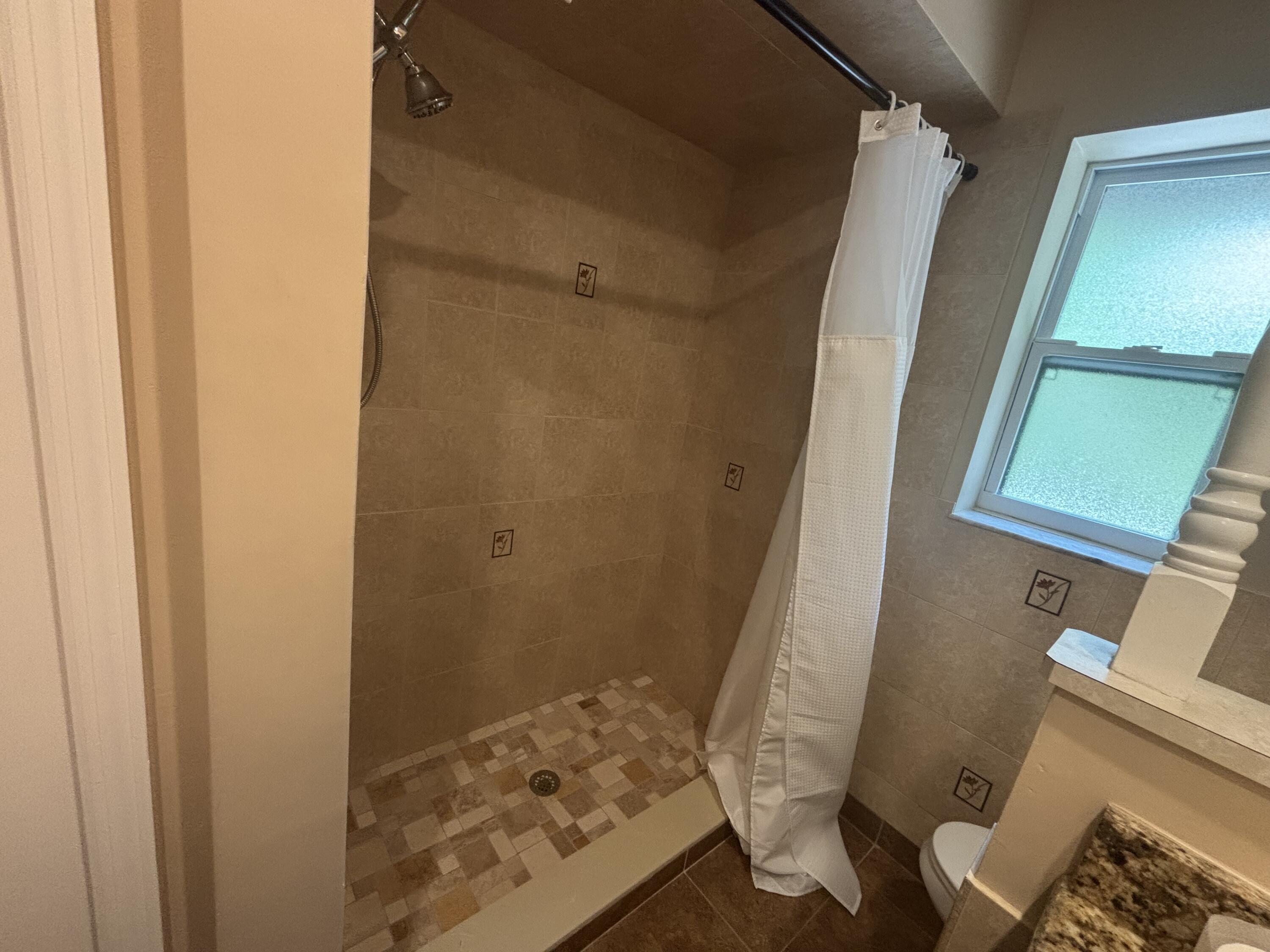 1257 Southeast Airoso Boulevard, Unit B Port St. Lucie, FL 34983 - Photo 10 of 12 a bathroom with a sink and toilet