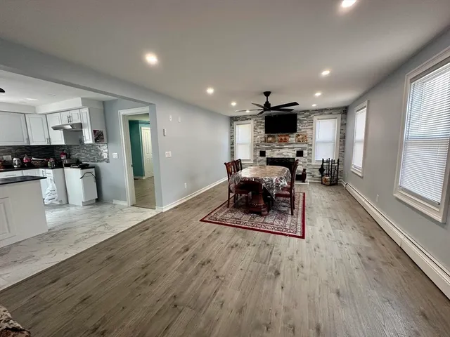 a living room with furniture wooden floor and a flat screen tv
