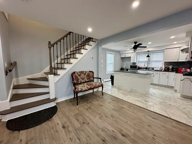 a view of kitchen with sink and wooden floor