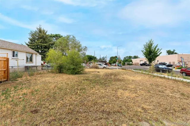 a view of a house with a yard and street
