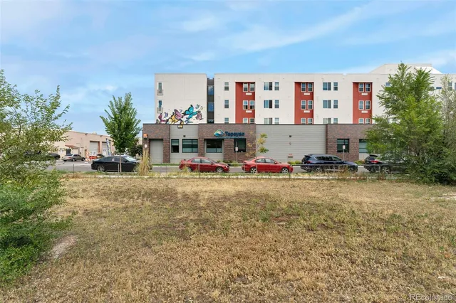 a view of swimming pool with outdoor seating and house in the background