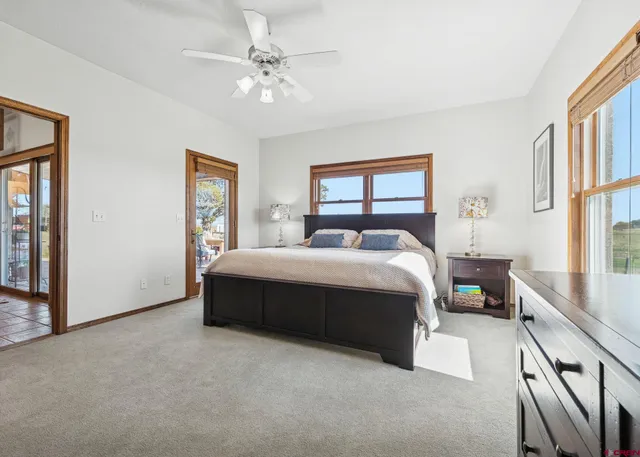 a bedroom with a large bed and a chandelier