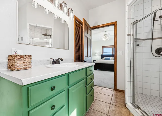 a en suite bathroom with a sink and a mirror