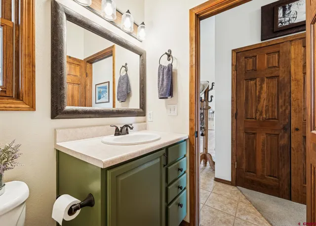 a bathroom with a sink a toilet and mirror