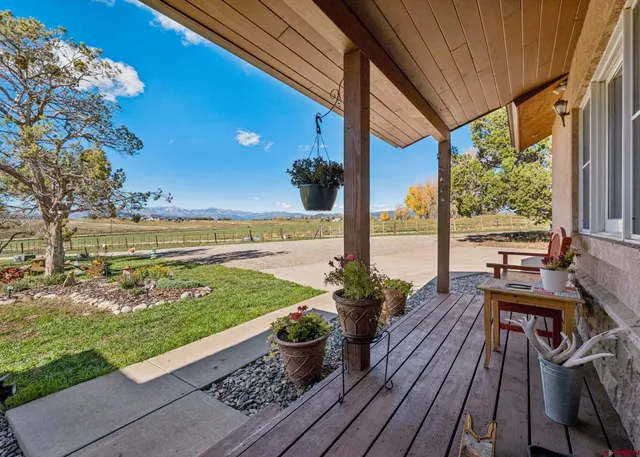 a view of a balcony with wooden floor
