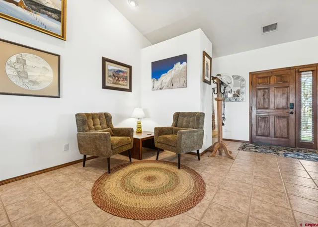 a living room with furniture a couch and dresser