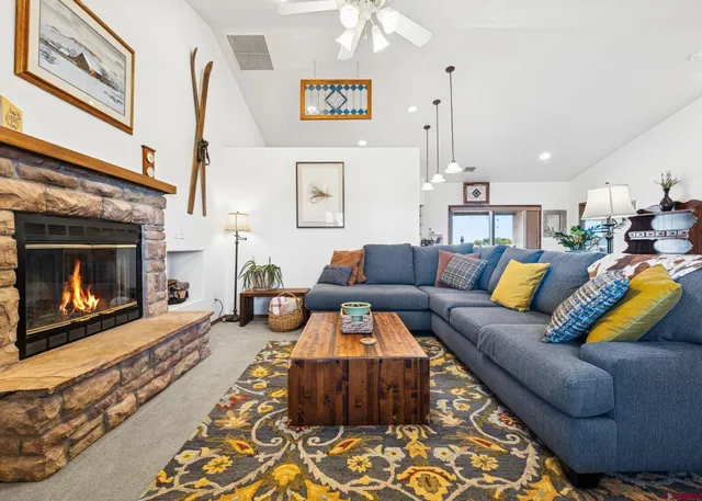 a living room with furniture and a fireplace