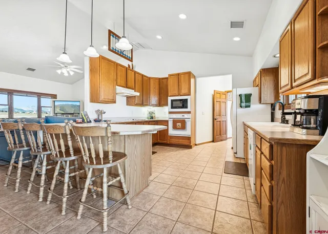 a large kitchen with lots of counter space and windows