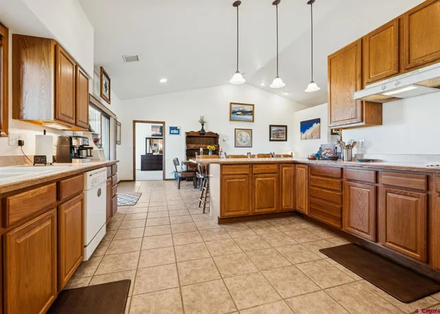 a large kitchen with stainless steel appliances lots of counter space cabinets and a sink
