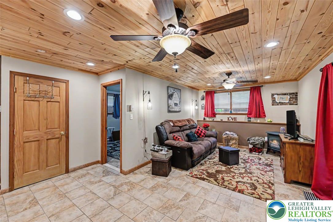 386 Upper Rdg Drive Effort, PA 18330 - Photo 30 of 56 A relaxed living area presents a warm wood plank ceiling with recessed lighting and two ceiling fans.